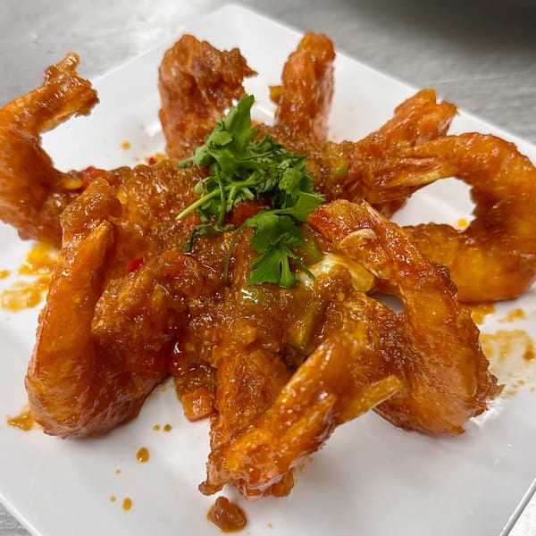 Gourmet Asian 888's honey garlic shrimp, glistening with sauce and garnished with fresh cilantro.