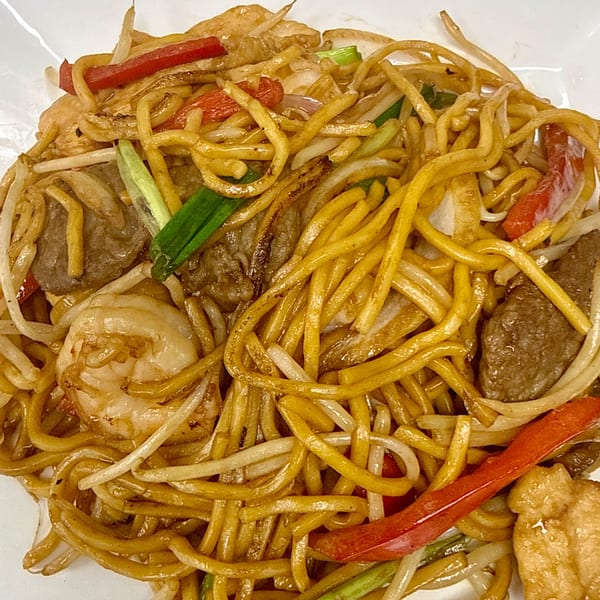 Close-up of Gourmet Asian 888's Chinese chow mein with noodles, shrimp, beef, and vegetables.