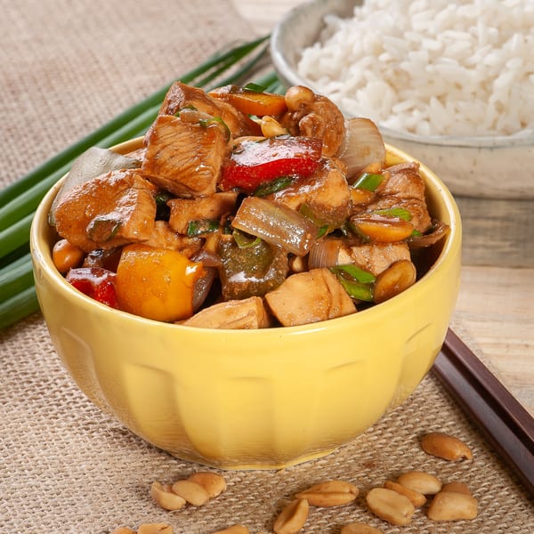 Gourmet Asian 888's Kung Pao Chicken with peanuts, bell peppers, and onions, served with white rice.